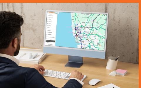 Gestor de frota a analisar rotas e deslocações de viaturas numa plataforma de monitorização GPS em tempo real.